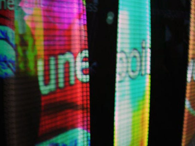 Close-up of the Logtime Twister installation showing projected words and images on vibrating elastic strings